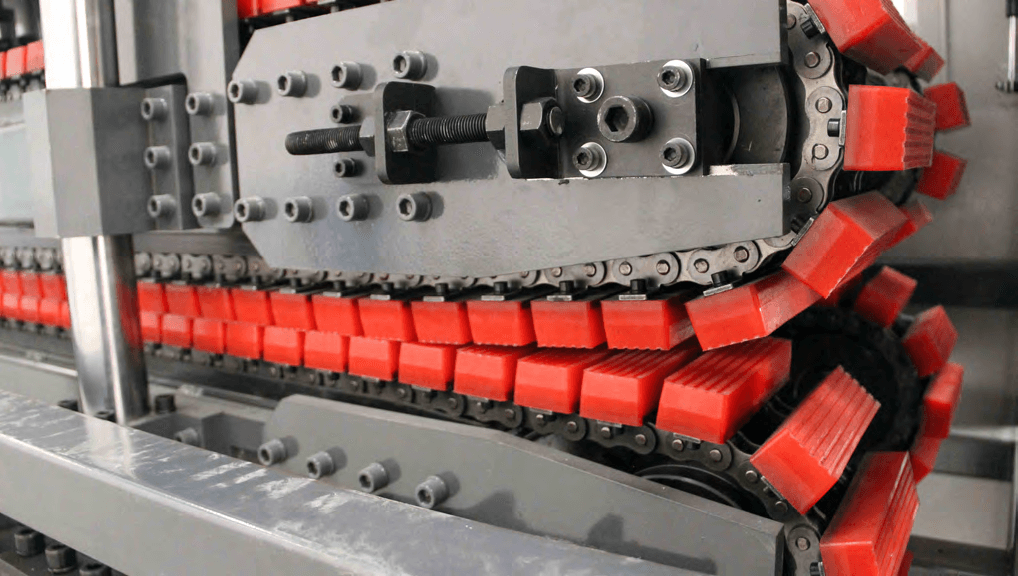 Continuous caterpillar tracks and red profile-gripping pads, from the supplier equipment catalogue